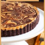 Vertical closeup photo of a Ridiculously Easy Caramel Cream Cheese Tart on a white pedestal serving plate.