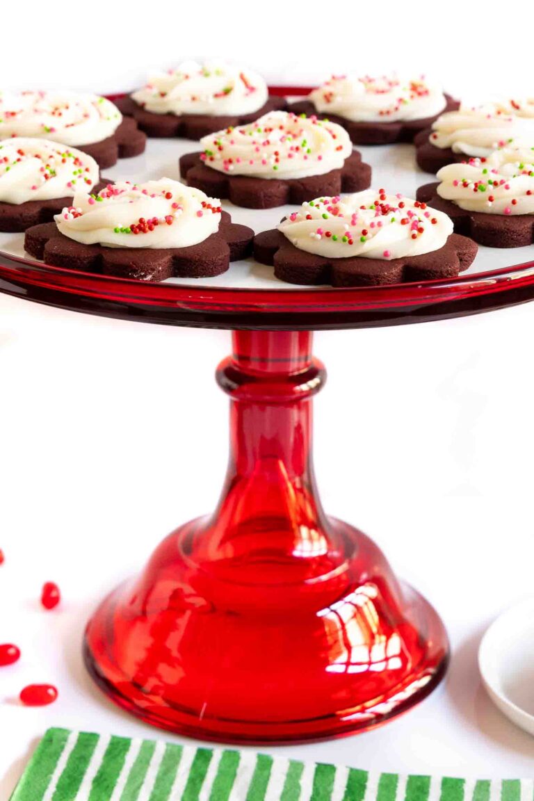 Chocolate shortbread with almond buttercream on a red glass cake stand.