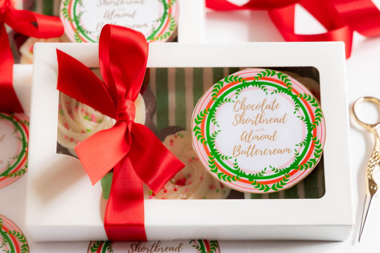 Horizontal photo of a decorative gift box wrapped with red ribbon and personalized with a custom label for gift-giving.