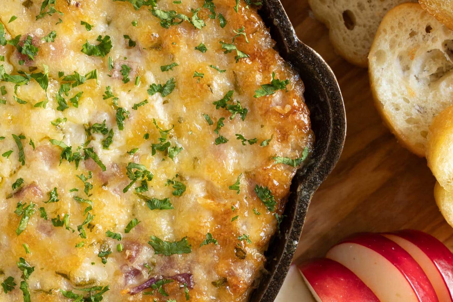 Horizontal extreme closeup overhead photo of a pan of Ridiculously Easy Hot Onion Dip.