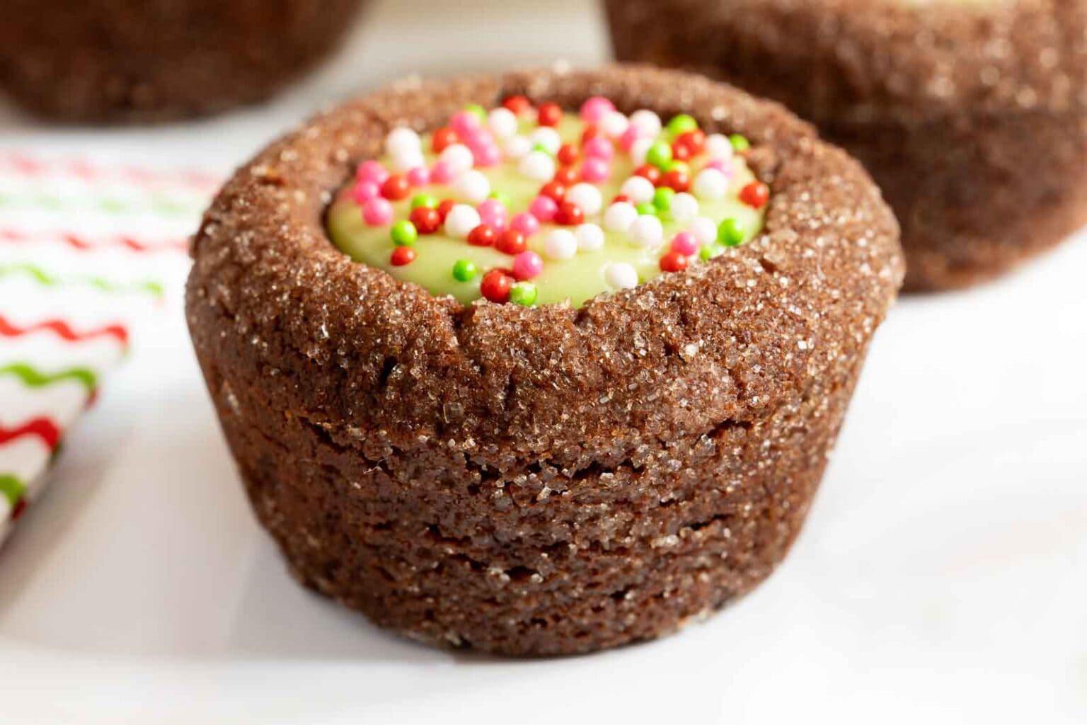 Horizontal extreme closeup photo of a Peppermint Thumbprint Brownie Bite.
