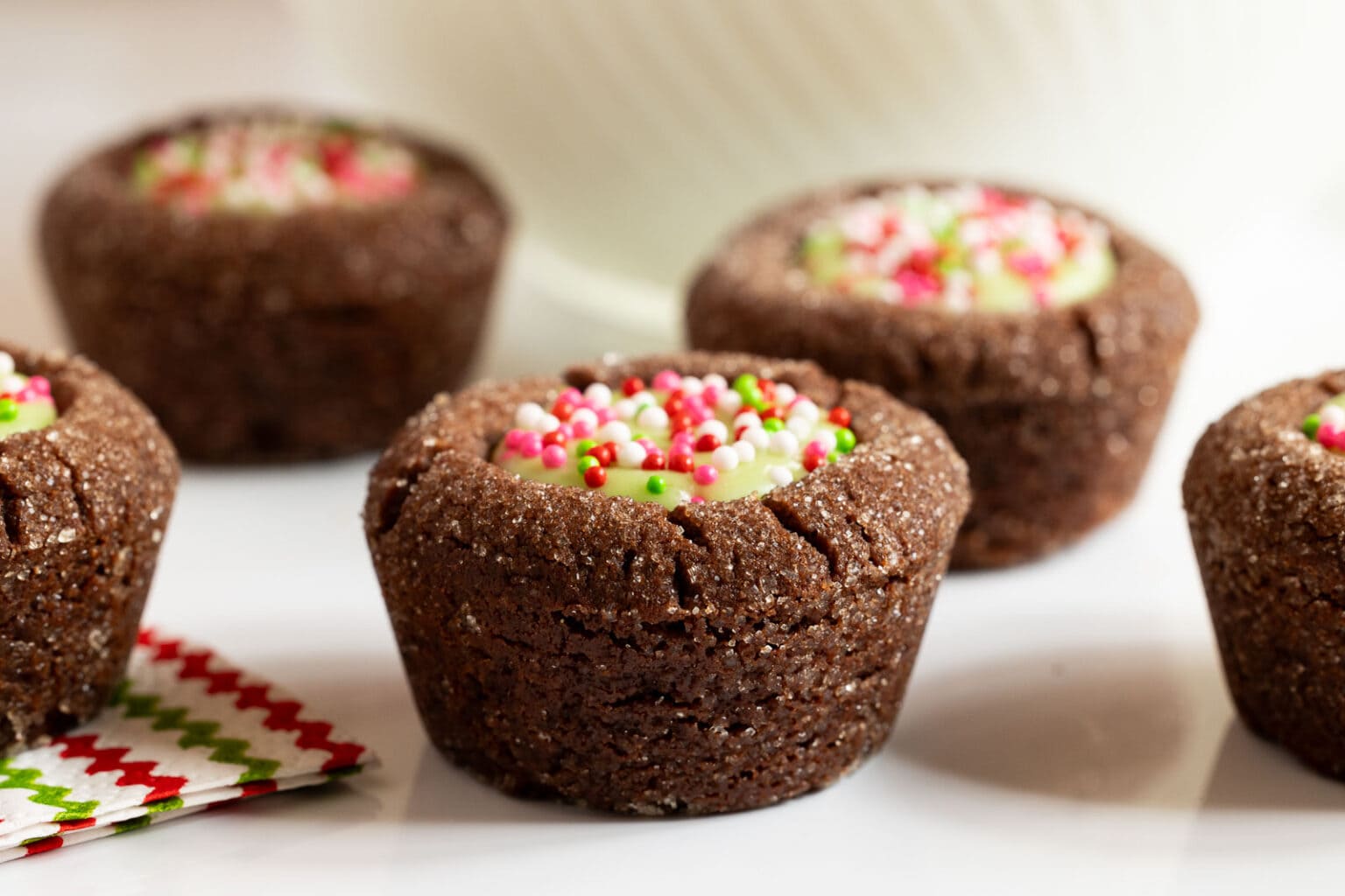 Horizontal closeup photo of a batch of Peppermint Thumbprint Brownie Bites.