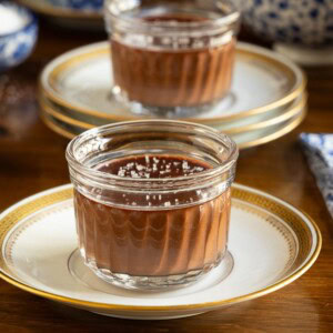 Horizontal closeup photo of a batch of Ridiculously Easy 5 Minute Chocolate Mousse desserts in class cups sprinkled with sea salt.