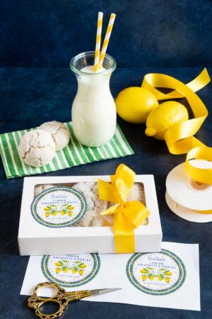 a white box wrapped with bright yellow ribbon with a custom label for gifting and filled with Lemon Amaretti cookies