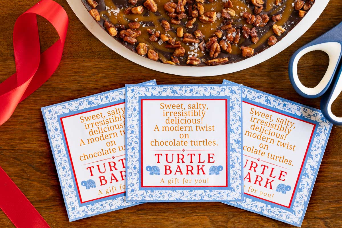 Horizontal overhead closeup photo of Ridiculously Easy Chocolate Caramel Turtle Bark labels for custom gift giving.