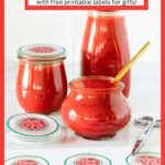 Vertical photo of jars of Ridiculously Easy Fresh Strawberry Coulis with custom labels for gift giving.