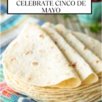 Vertical closeup photo of a stack of Homemade Flour Tortillas on a colorful towel with a cup of salsa in the background. A title block is at the top of the photo.