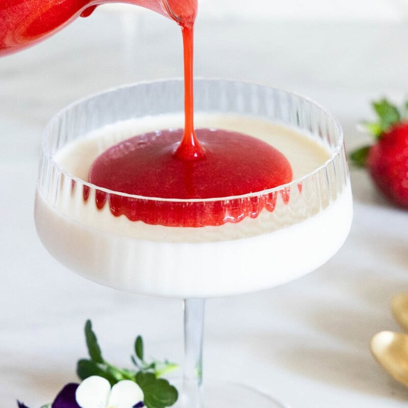 Strawberry Coulis poured onto Vanilla Bean Panna Cotta.