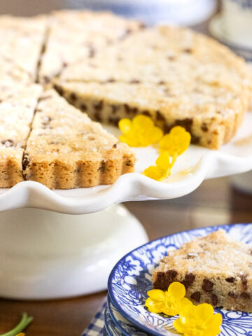 Horizontal photo of Chocolate Chip Shortbread on a white scalloped serving plate.