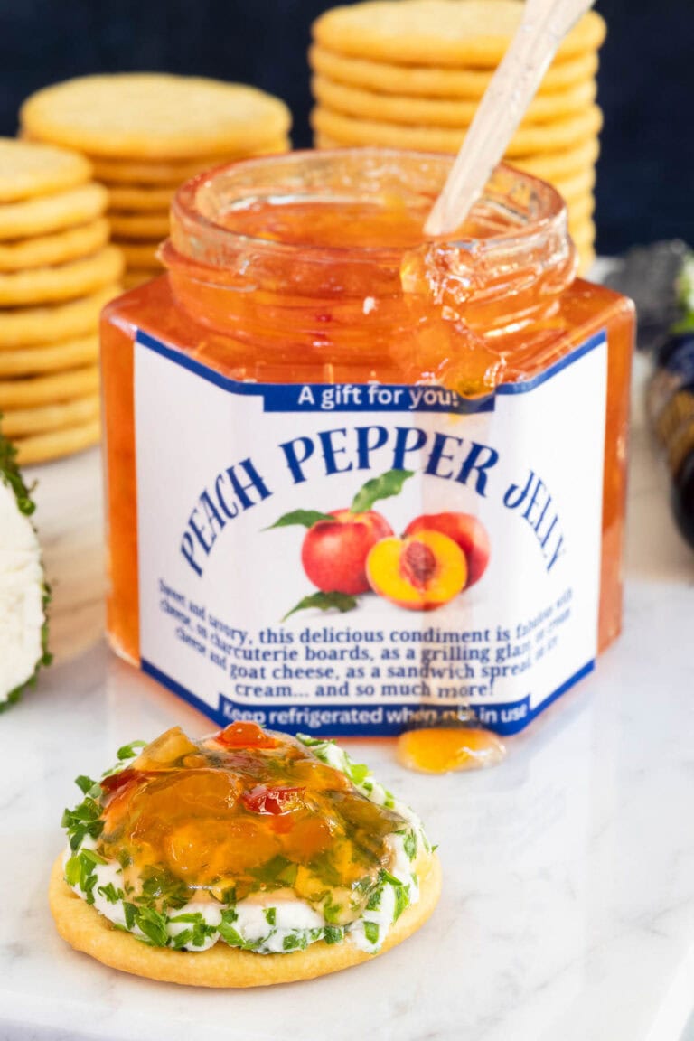 Peach Pepper Jelly in a glass jar with a printed label.