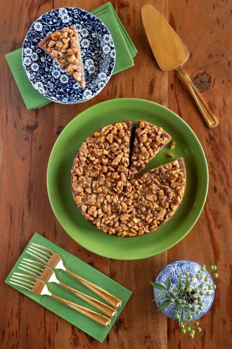 Caramelized walnut banana cake on a green plate.