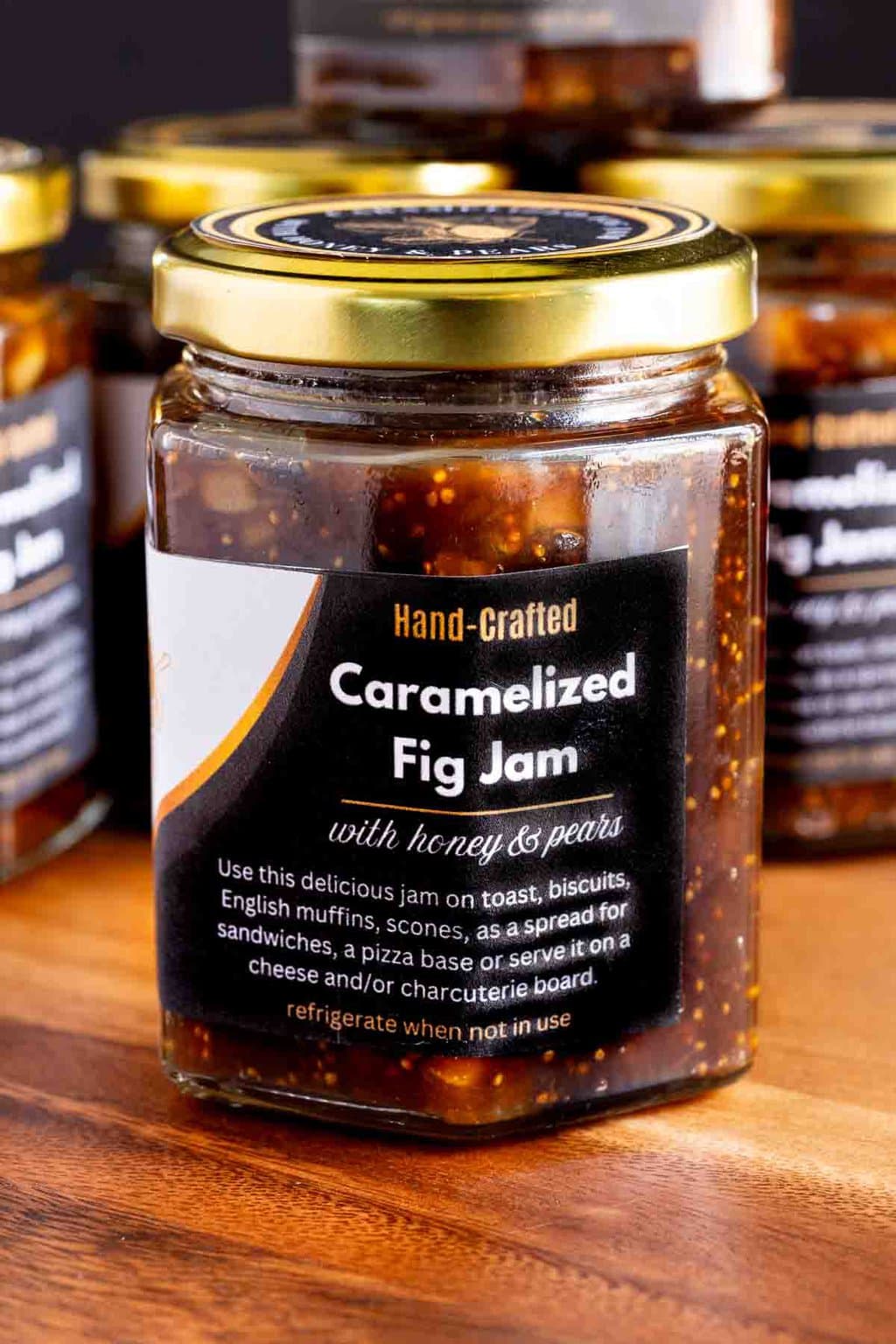 Caramelized Fig Jam with Honey and Pears - thecafesucrefarine.com Vertical closeup photo of a jar of Caramelized Fig Jam with Honey and Pears with a custom label for gift giving.