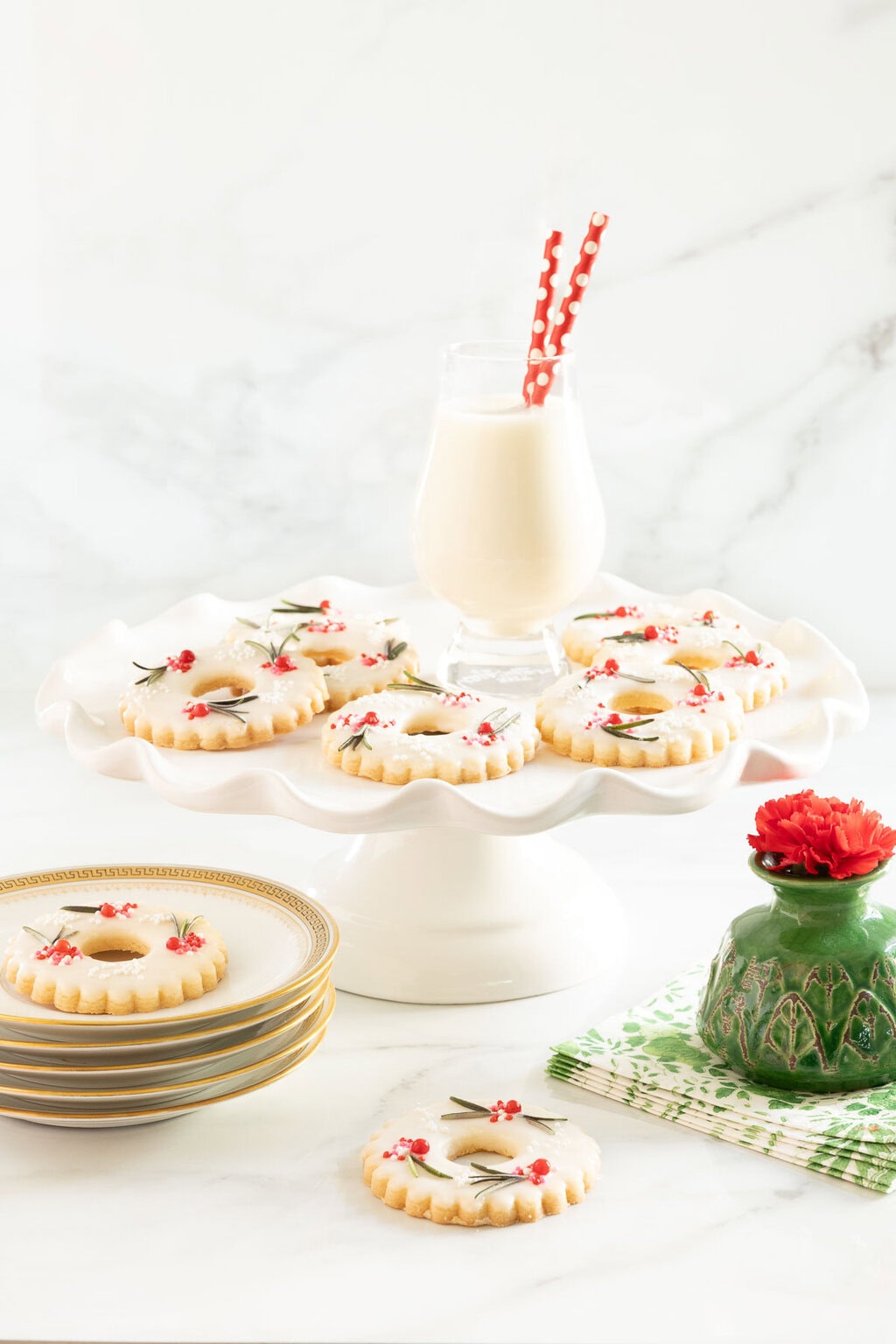 Vertical photo of a batch of Berries on the Wreath Shortbread Cookies on a white pedestal serving plate.