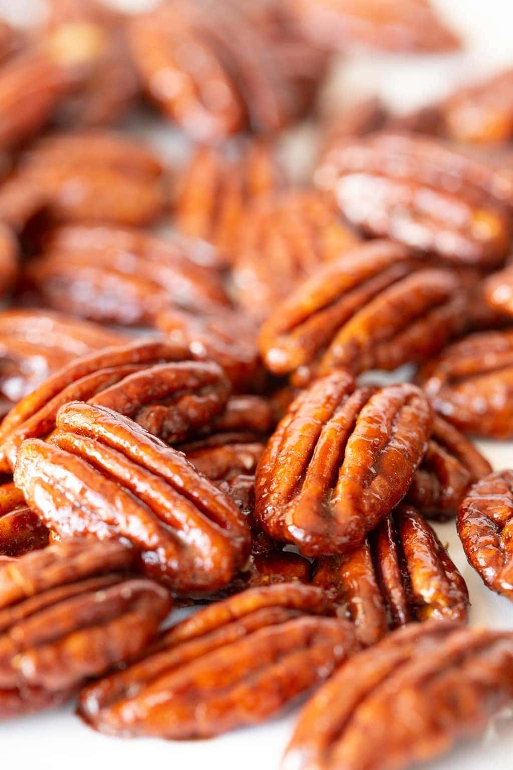 extreme closeup of glazed pecans in a pile