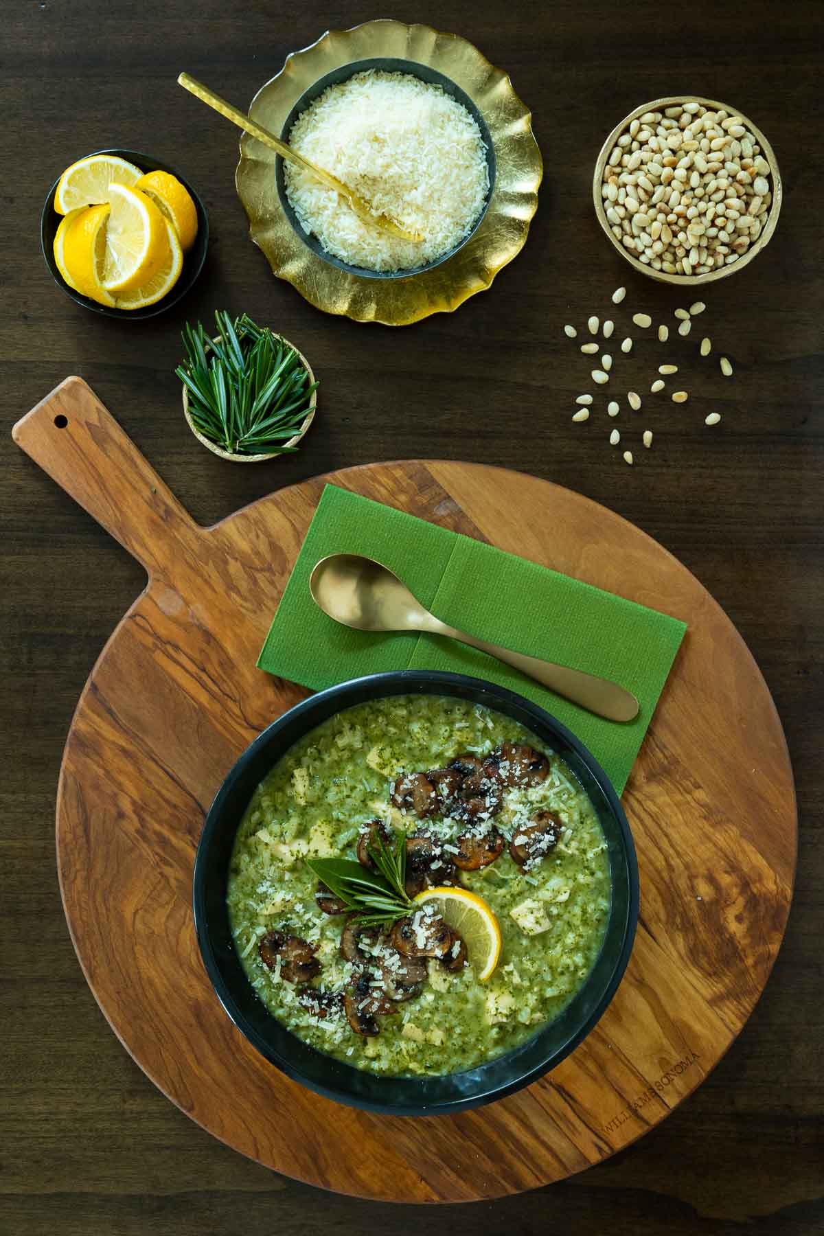 Vertical overhead photo of a bowl of Marry Me Chicken and Spinach Risotto garnished with caramelized mushrooms.