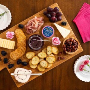Horizontal overhead photo of a charcuterie board featuring Ridiculously Easy Merlot Wine Jelly.