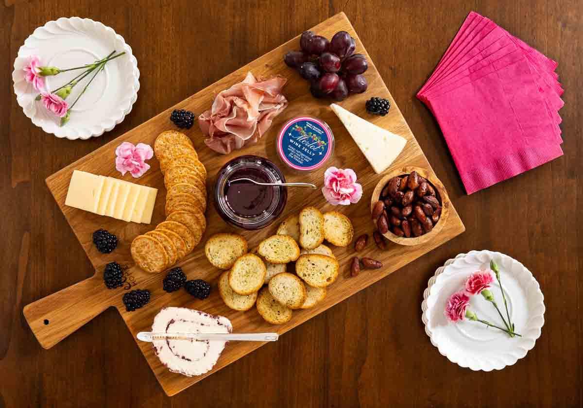 Ridiculously Easy Merlot Wine Jelly - thecafesucrefarine.com Horizontal overhead photo of a charcuterie board featuring Ridiculously Easy Merlot Wine Jelly.