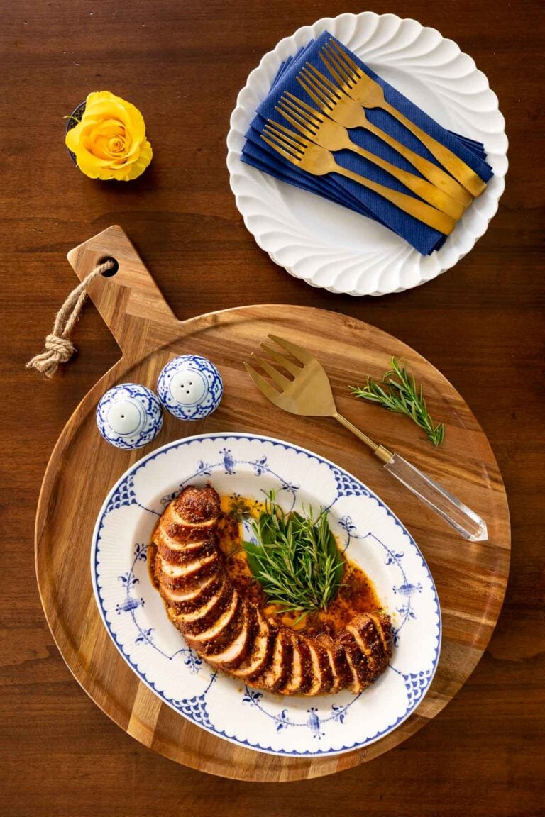 Oven roasted pork tenderloin on a white oval platter.