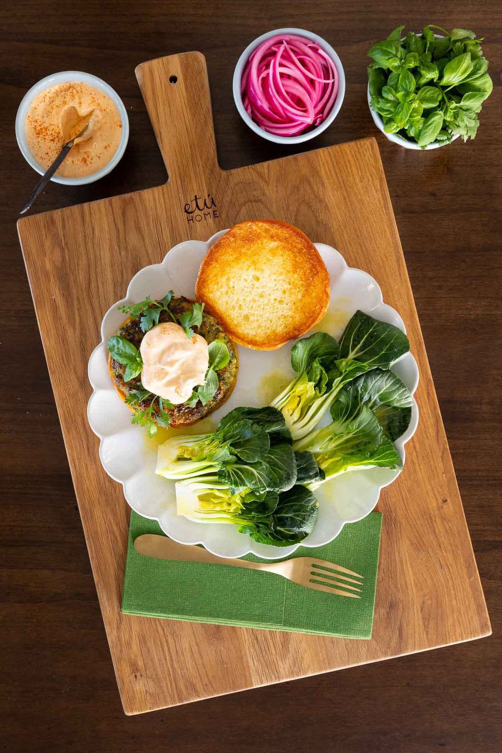 Fresh Herb Chicken Burgers on a white plate with small bowls of toppings