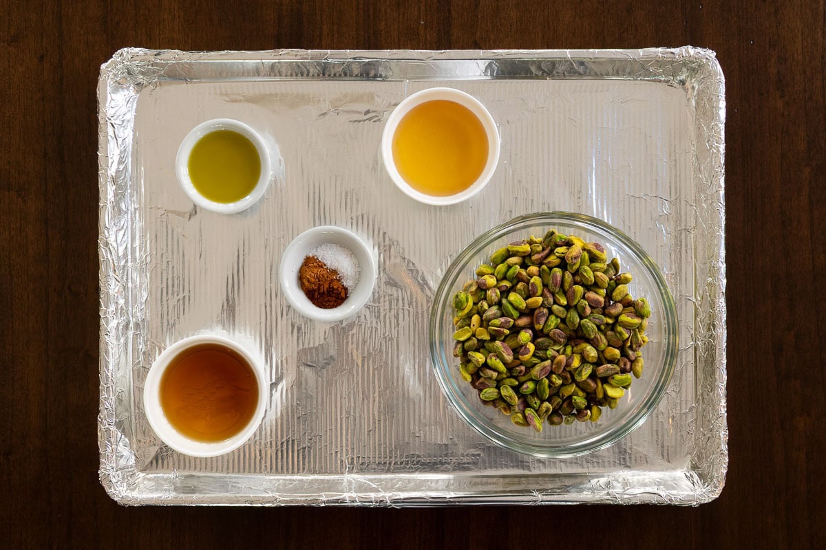 Horizontal overhead process photo of the ingredients needed to make Ridiculously Easy Candied Pistachios.