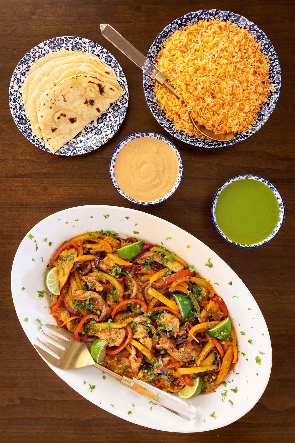 Overhead photo of an oval serving plate of the finished Sheet Pan Chicken Fajitas.
