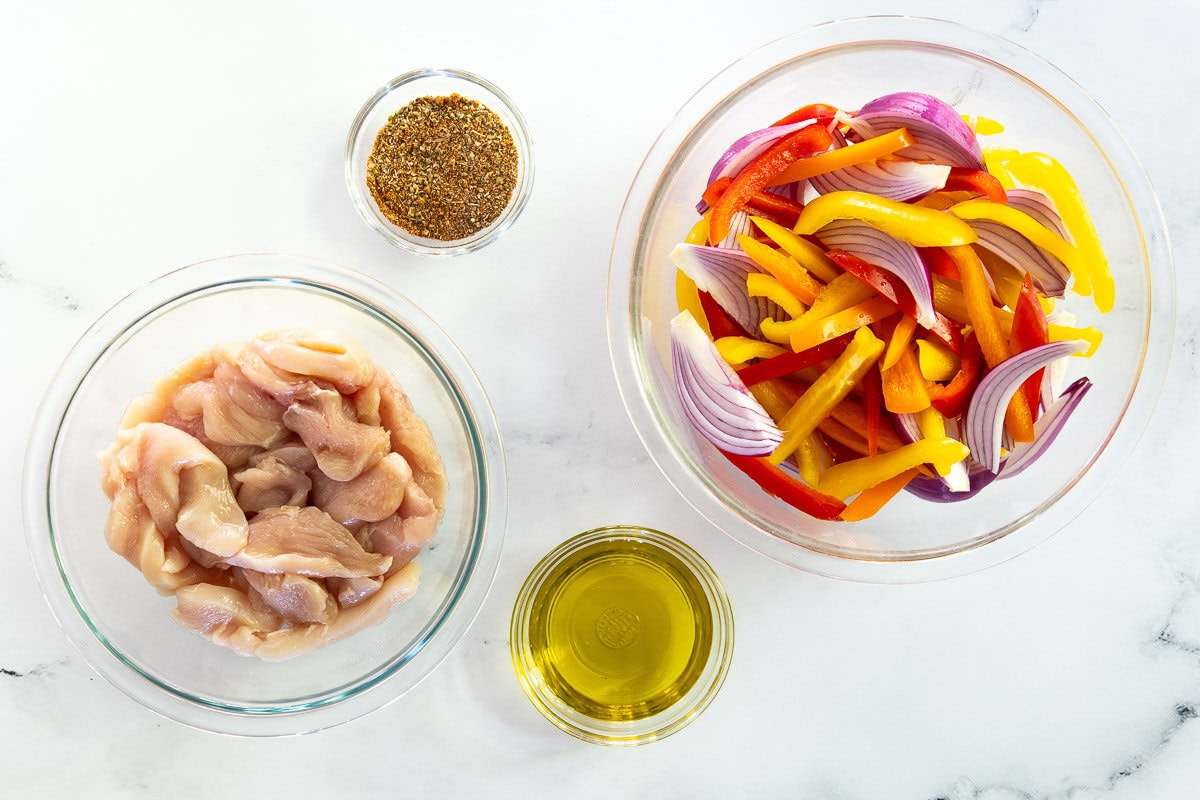 Overhead ingredient process photo for making Sheet Pan Chicken Fajitas.