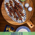 Grilled Korean beef skewers on a patterned platter with gremolata, salt and pepper shakers, and styled tableware, overlaid with “Grilled Korean Beef Skewers” text
