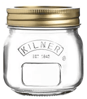 Glass mason jar with a gold lid and the name Kilner embossed.