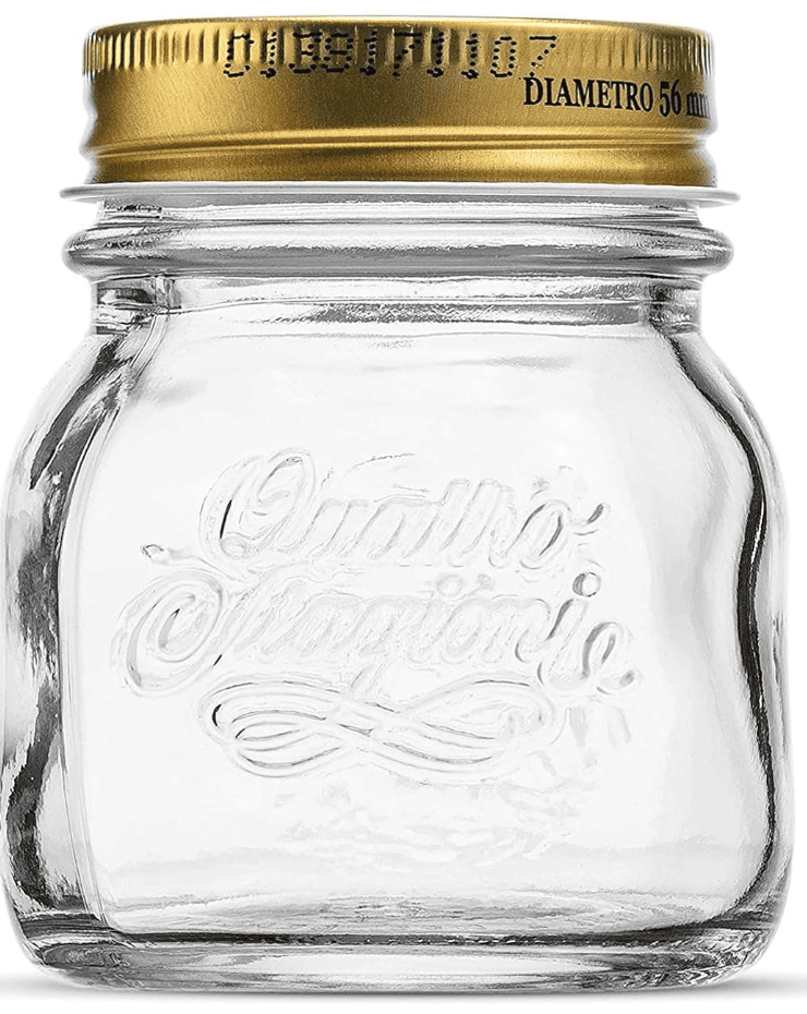 Curvy Italian mason jar with a gold lid and engraved script writing.