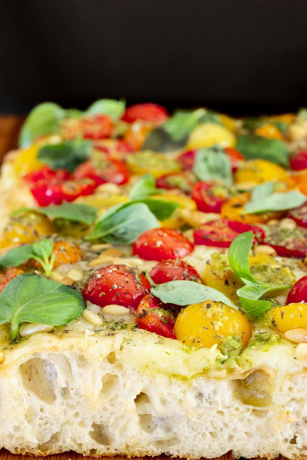 close up of pizza margherita with fresh tomatoes and basil