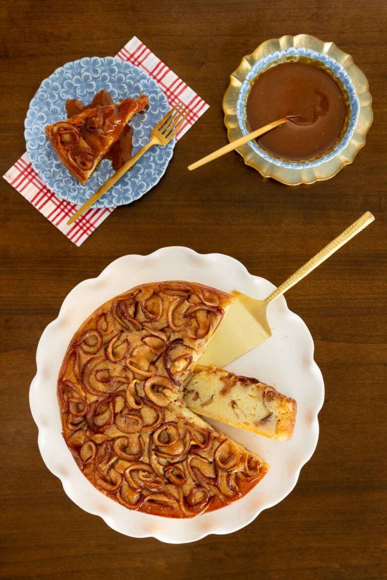 Apple Ricotta Cake on a white platter cut into slices.