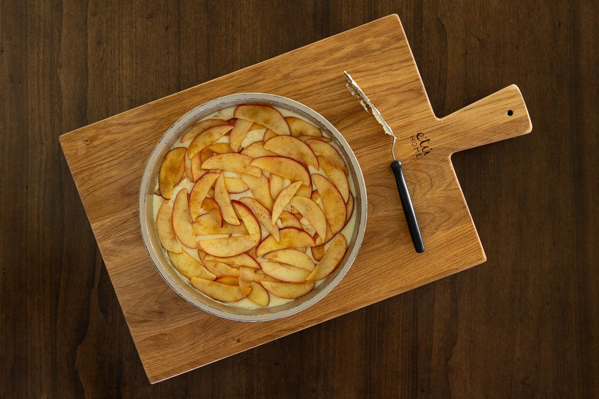 Step showing creamy ricotta batter mixed in a glass bowl with a whisk, highlighting the easy one-bowl preparation for Italian Apple Ricotta Cake.