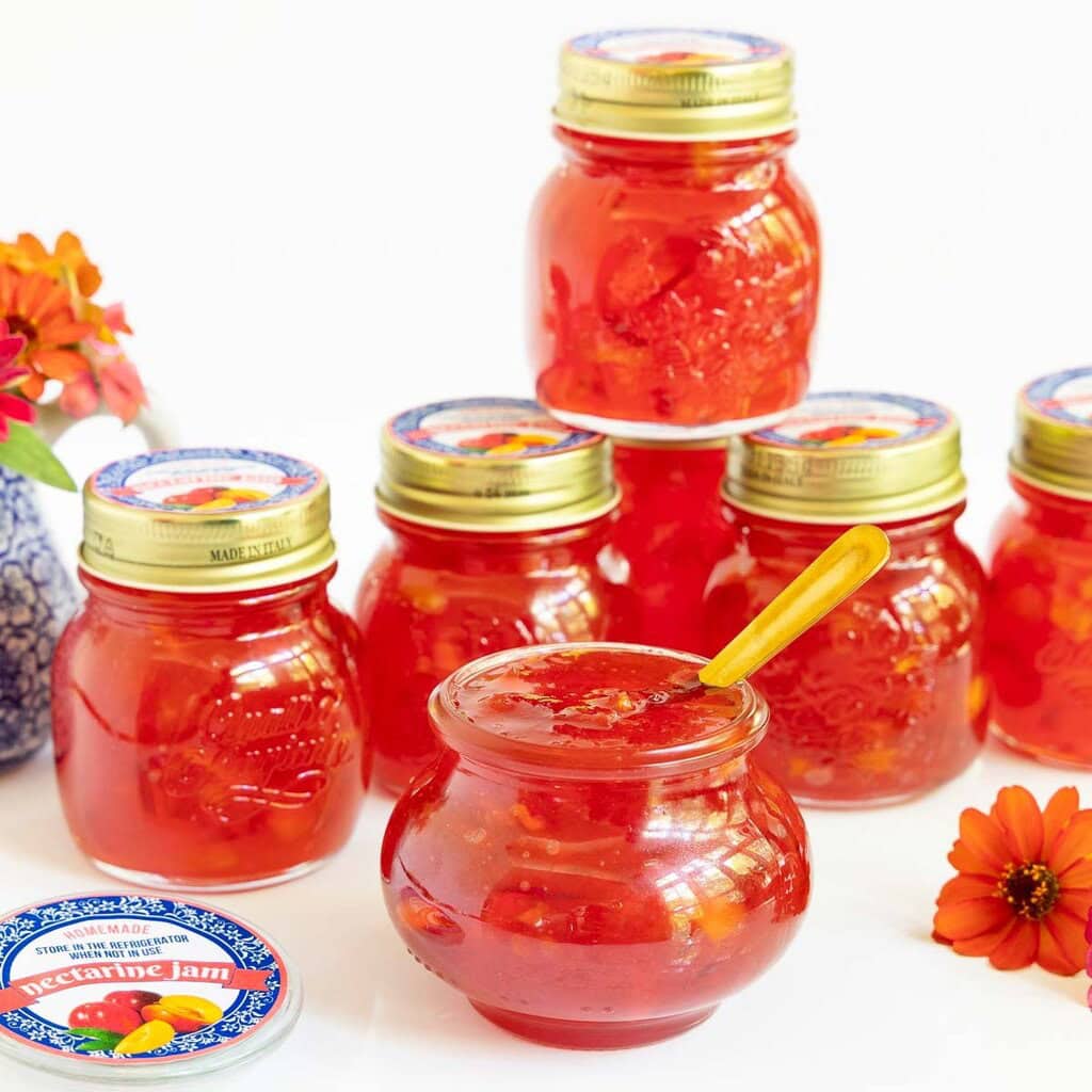 Several small jars of homemade jams and jellies.