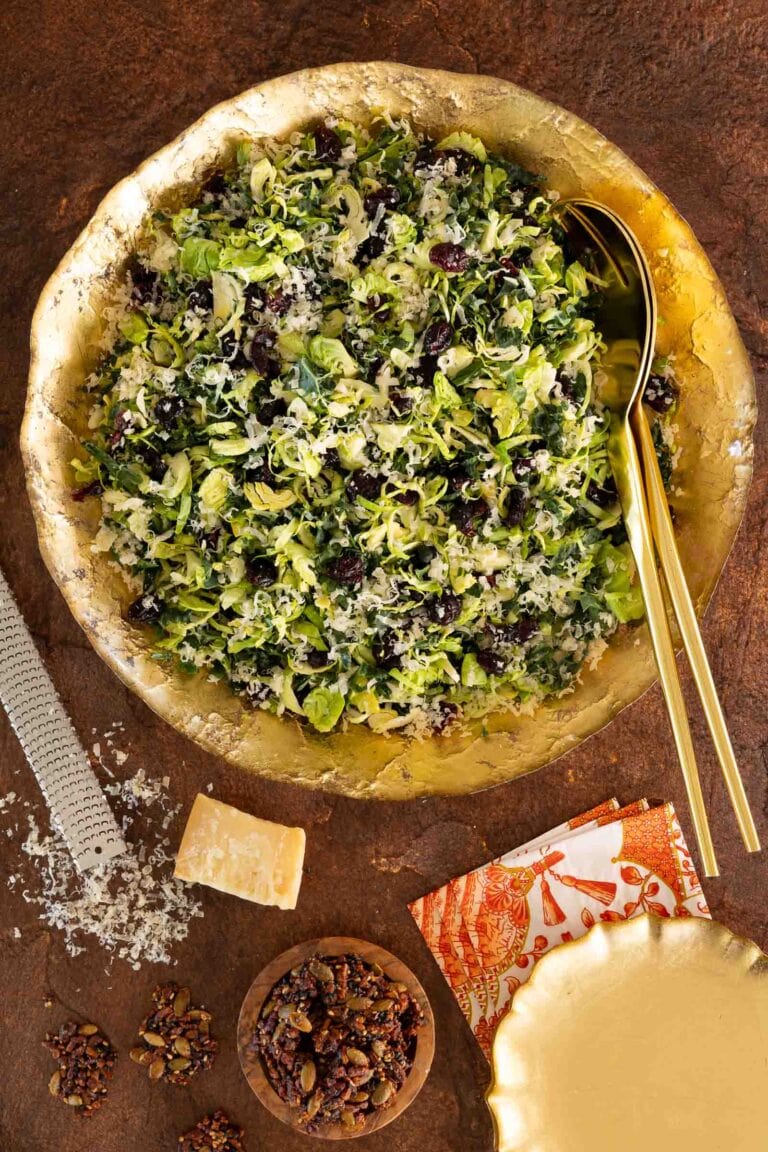 Shaved Brussels sprouts salad in a gold bowl.