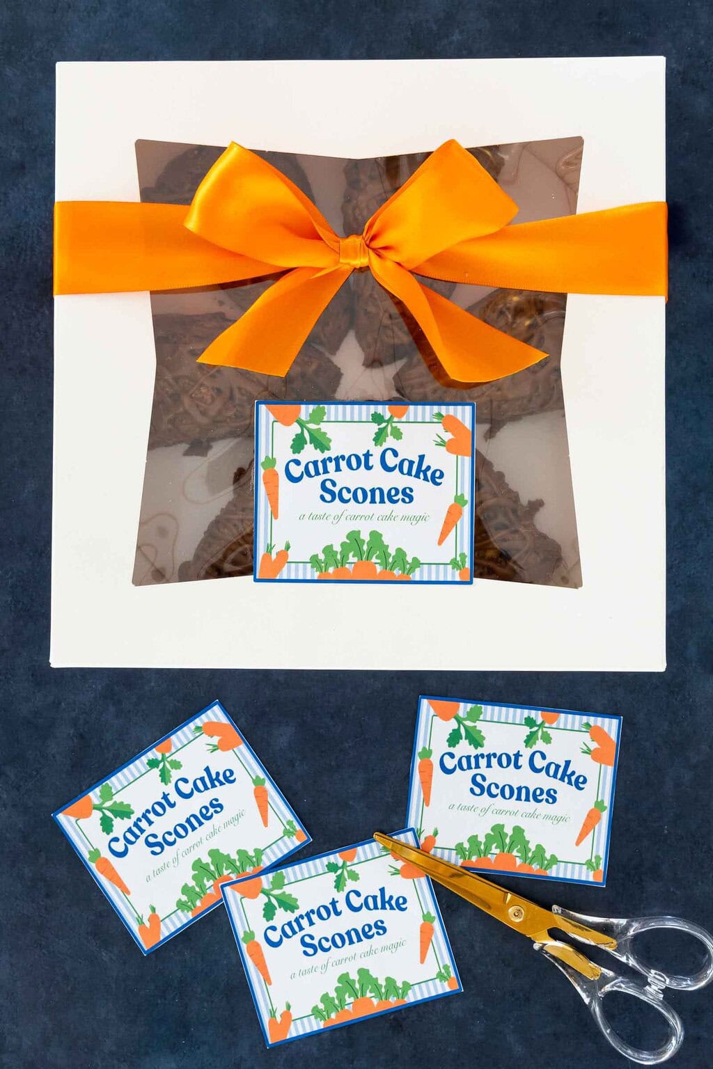 Carrot cake scones in a bakery box with orange ribbon and printable gift labels