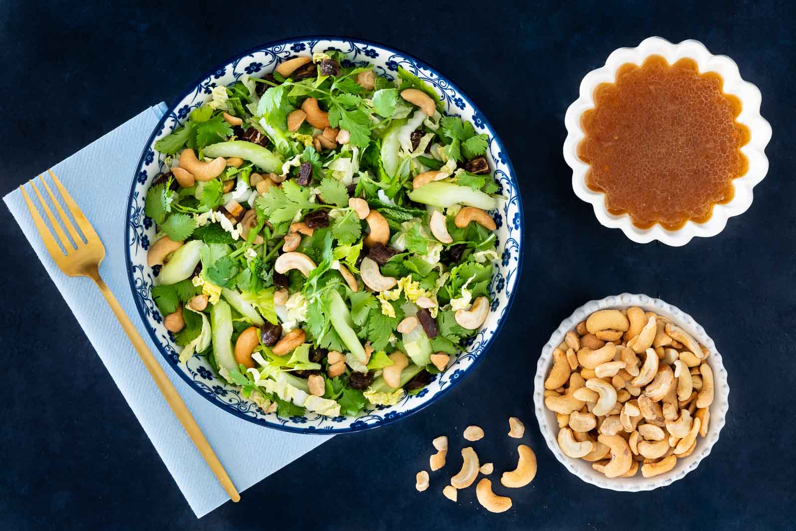 Asian celery date salad with herbs and cashews served with lime sesame dressing on the side.