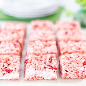 Close-up of strawberry rice krispie treats showing gooey marshmallow pockets and pieces of freeze-dried strawberries