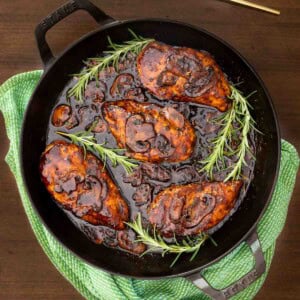 One-Pan Balsamic Rosemary Chicken with mushrooms in a rich balsamic rosemary pan sauce served in a cast iron skillet.