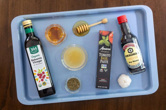 Ingredients for balsamic rosemary pan sauce including balsamic vinegar, honey, chicken broth, tomato paste, garlic and Italian seasoning.