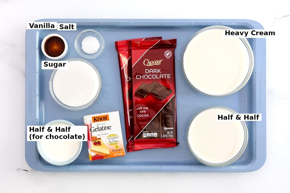 Labeled ingredients for chocolate panna cotta including heavy cream, half-and-half, sugar, vanilla, salt, bittersweet chocolate and unflavored gelatin.