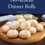 Pinterest pin featuring homemade Italian no-knead dinner rolls on a wooden serving board with text overlay reading "Italian No-Knead Dinner Rolls" and "Easy! No Mixer Needed."
