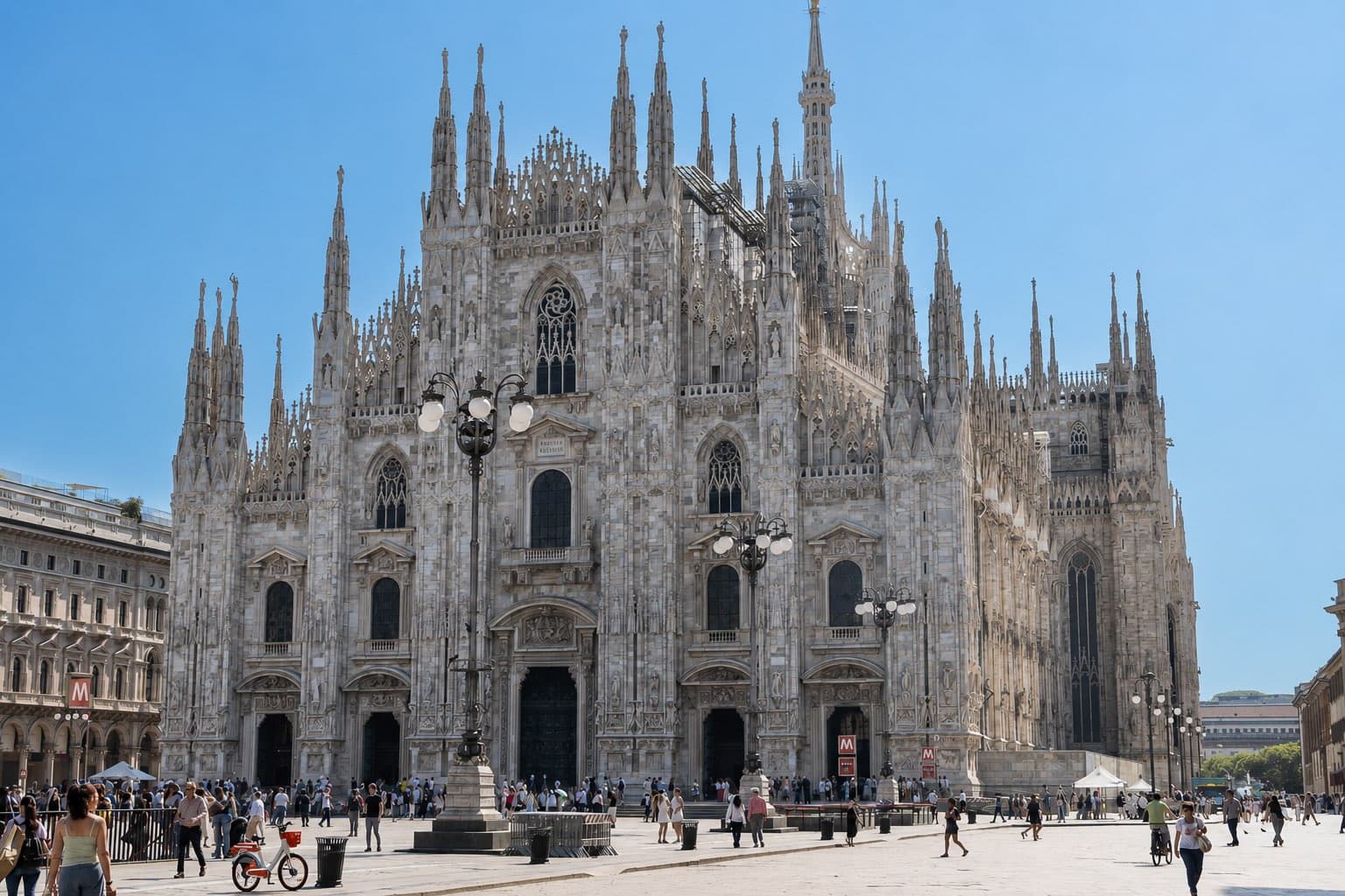 Front view of the Duomo di Milano (Milan Cathedral) in Piazza del Duomo, featuring its ornate Gothic architecture and marble façade.