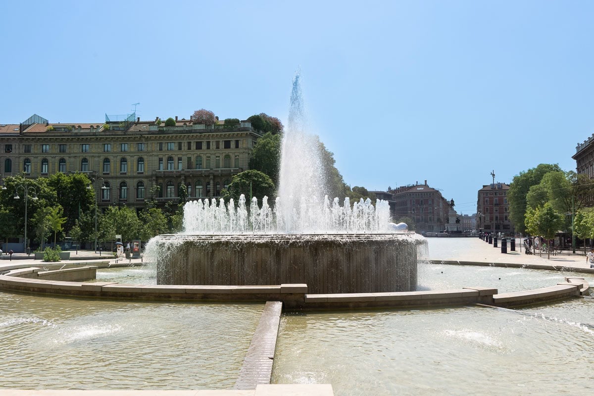 Large fountain in Piazza Castello in Milan, Italy, providing a refreshing oasis on a sunny summer day.