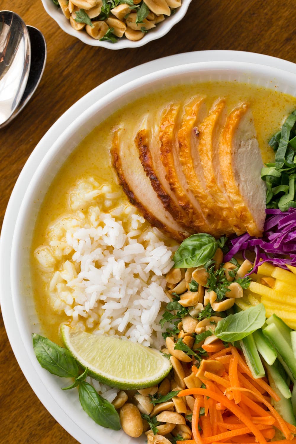 Overhead photo of a dish filled with the ingredients of Vietnamese Chicken and Rice Soup Bowls.