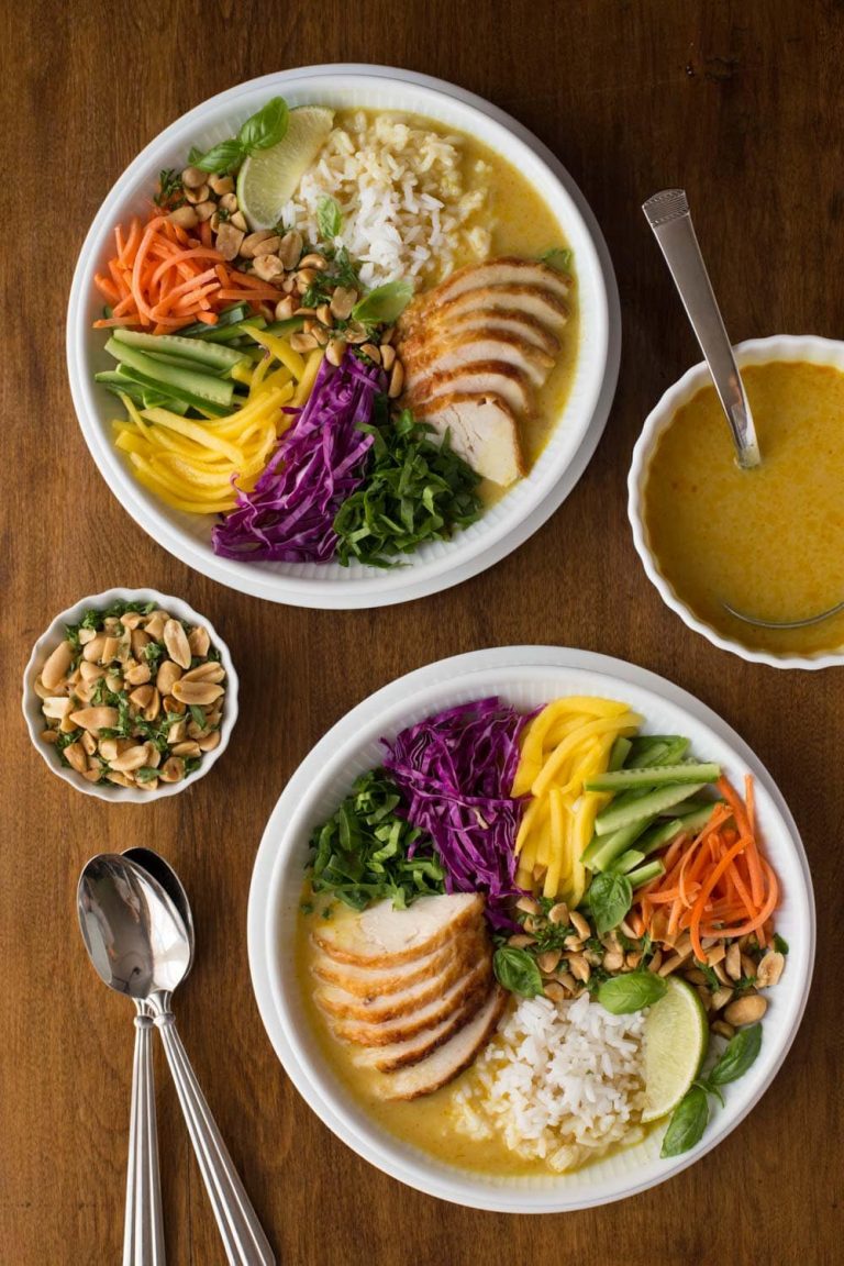 Overhead picture of two bowls of vietnamese chicken soup with lots of toppings