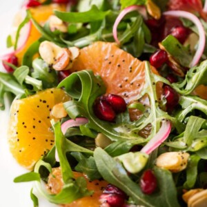 Vertical close up picture of Arugula Orange Salad with Lemon Ginger Dressing