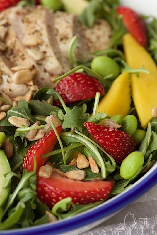 Closeup image of Arugula Chicken Salad with Honey Lime Dressing in a bowl.