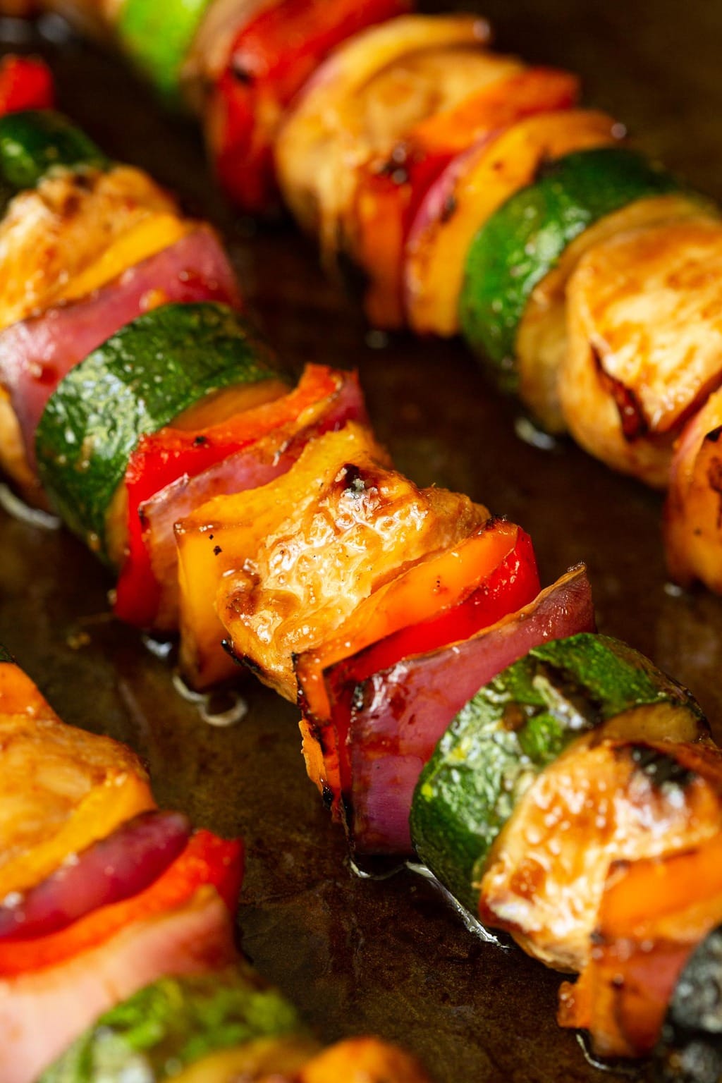 Close up vertical photo of Asian Grilled Chicken and Veggie Skewers.