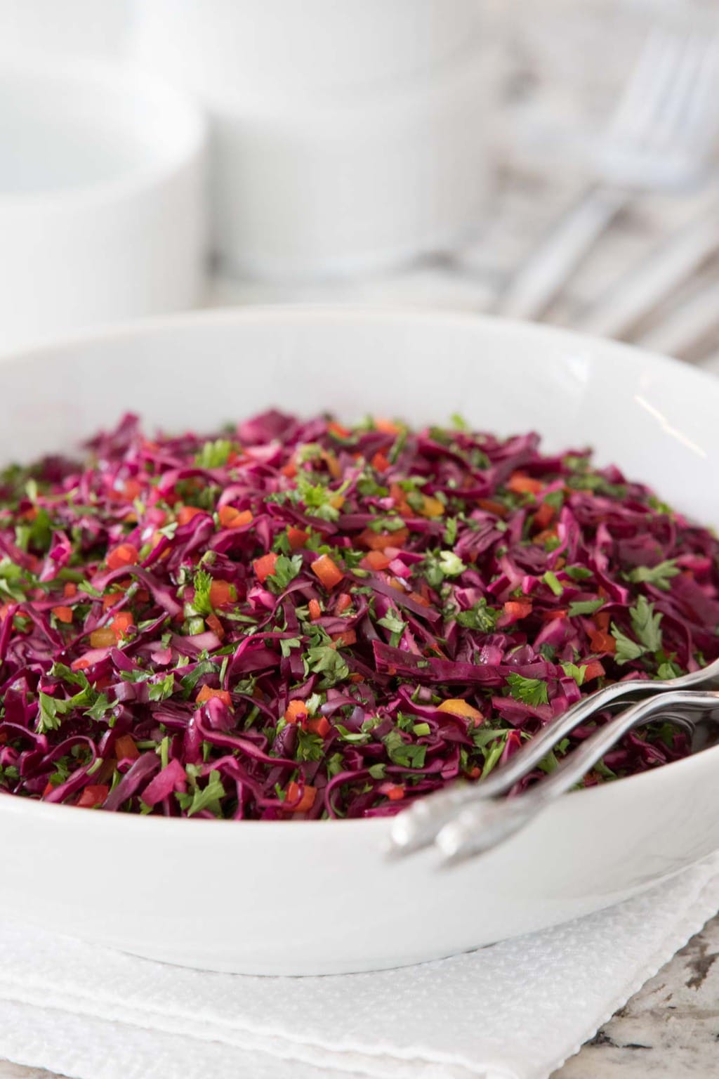 Photo of a white serving bowl of Asian Red Cabbage Slaw.