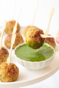 Vertical picture of Vietnamese Chicken Meatballs on toothpicks with dipping sauce